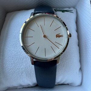 Lacoste unisex Cream Dial with Black Strap Watch in box.